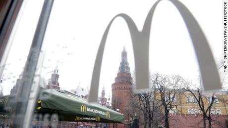 People walk outside a McDonald's restaurant on Manegnaya Square in Moscow, Russia in April 2014.