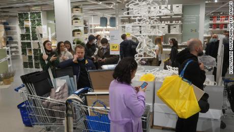 Shoppers wait in line to pay for their purchases at an IKEA store on March 3, 2022 in Moscow.