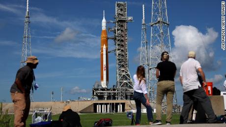 Photographers and reporters work near NASA's Artemis 1 rocket at the Kennedy Space Center on Monday.  A host of issues prevented booting afterwards.